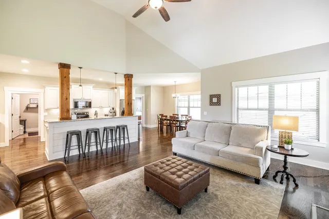 a living room with furniture and a ceiling fan