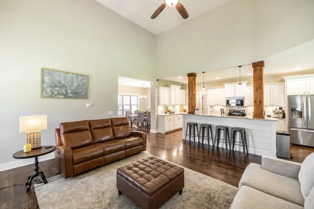 a living room with furniture and a ceiling fan
