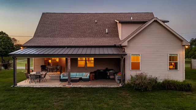 a view of a house with backyard and porch
