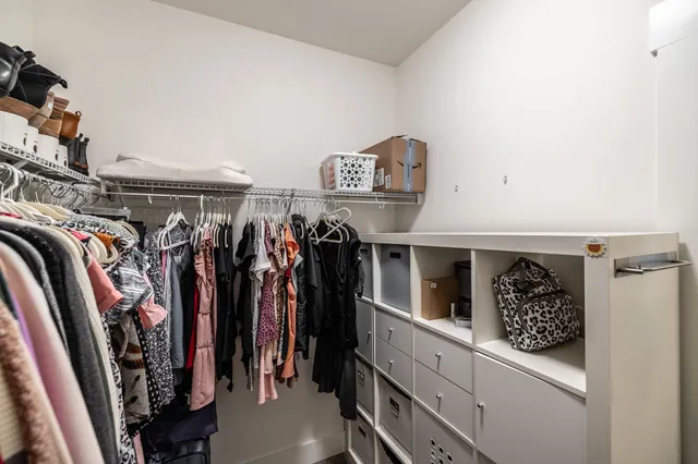 a view of a house with a big yard and potted plants