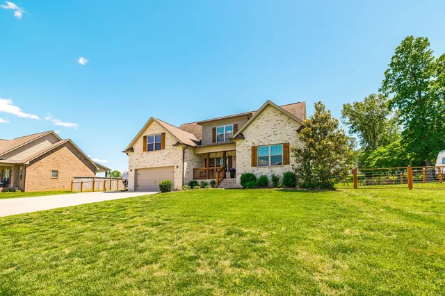 a front view of a house with a yard and garage