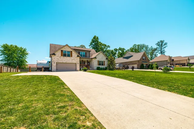 a front view of a house with a yard and garage