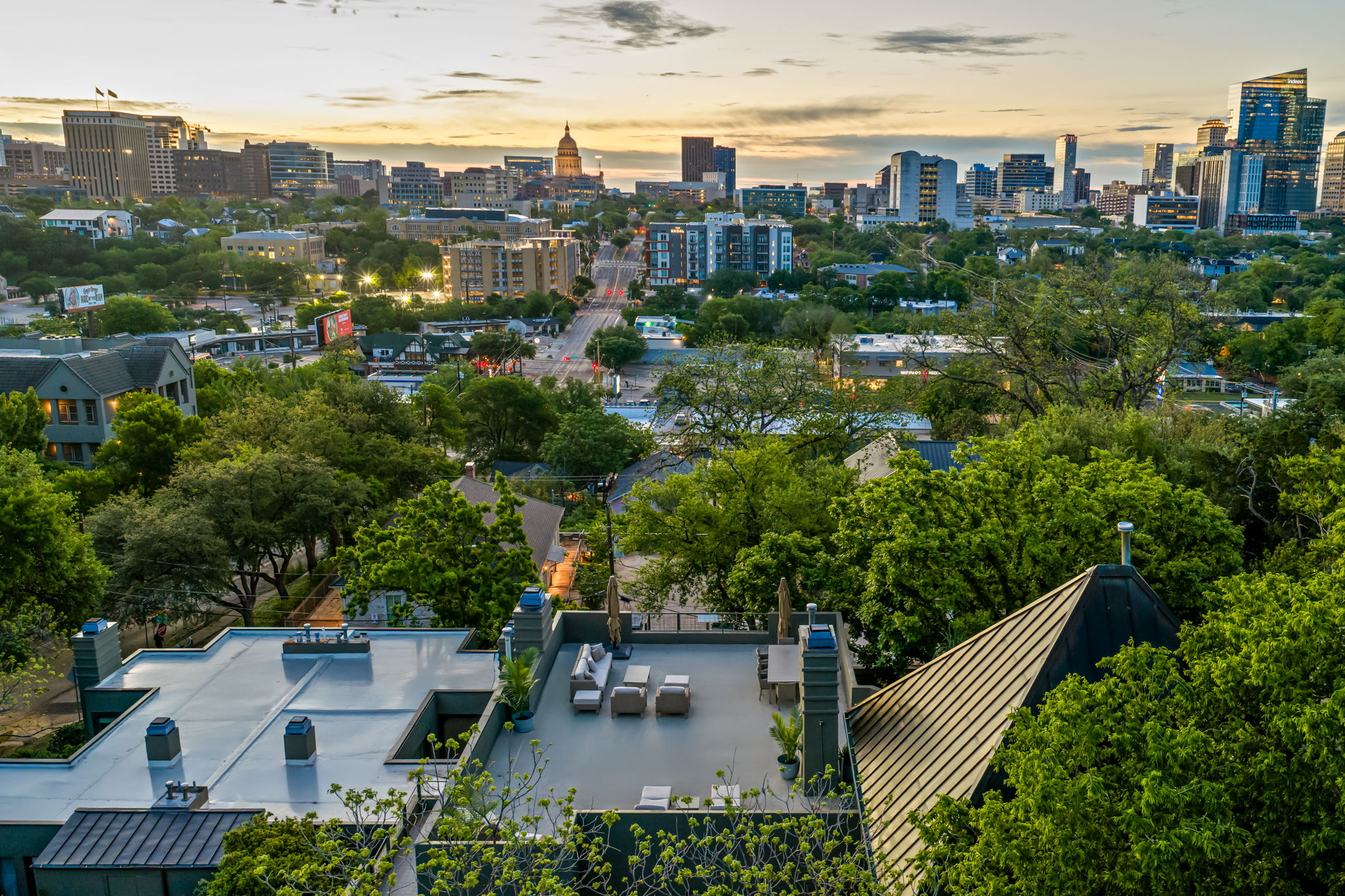 1111 West 12th Street, Unit 107 Austin, TX 78703 - Photo 6 of 38 Rooftop terrace with expansive cityscape backdrop, surrounded by mature trees