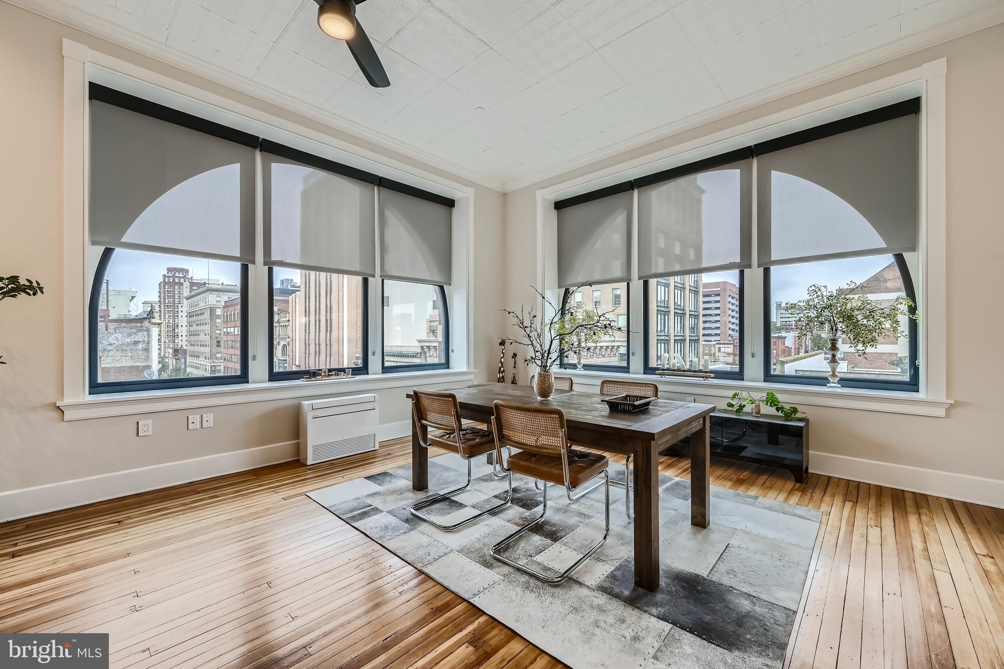 303 North Howard Street, Unit 601 Baltimore, MD 21201 - Photo 8 of 18 a dining room with wooden floor and a window