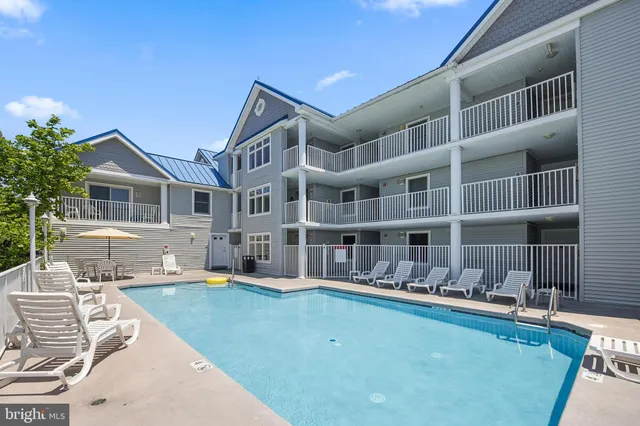 a swimming pool with outdoor seating and yard
