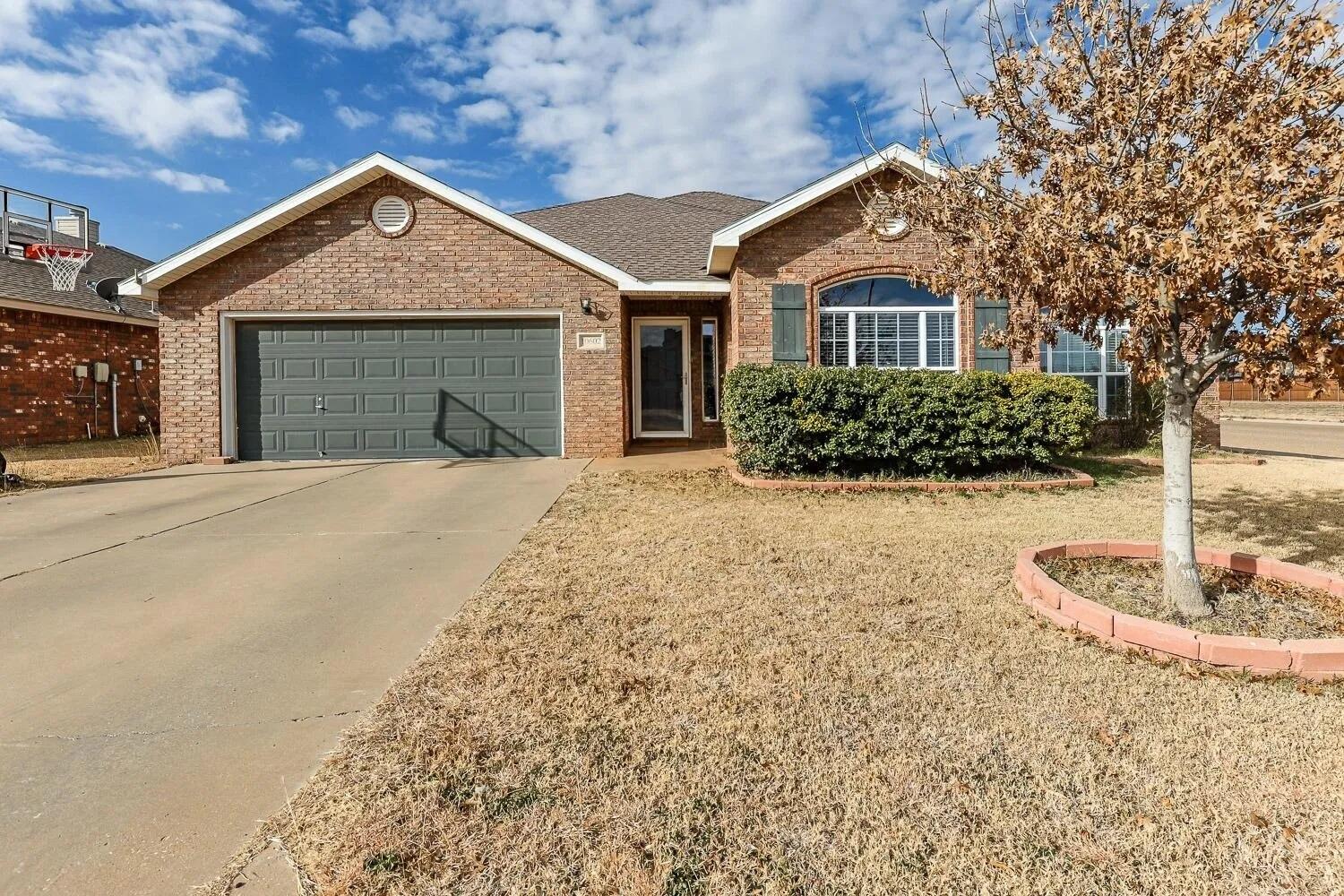 10602 Clinton Avenue Lubbock, TX 79424 - Photo 1 of 36 a front view of a house with a yard