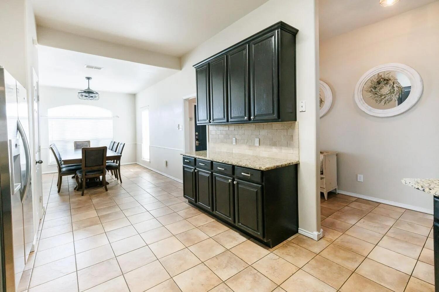 10602 Clinton Avenue Lubbock, TX 79424 - Photo 15 of 36 a kitchen with a cabinets and a stove top oven
