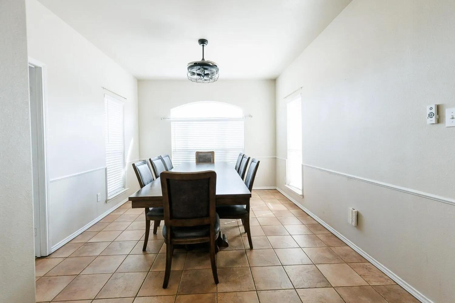 10602 Clinton Avenue Lubbock, TX 79424 - Photo 16 of 36 a view of a dining room with furniture and window