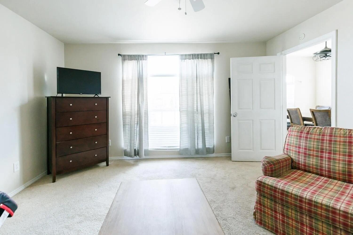 10602 Clinton Avenue Lubbock, TX 79424 - Photo 17 of 36 a bedroom with a bed and a television