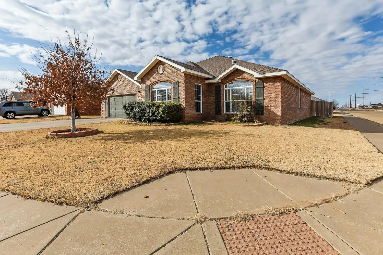 10602 Clinton Avenue Lubbock, TX 79424 - Photo 2 of 36 a front view of a house with a yard