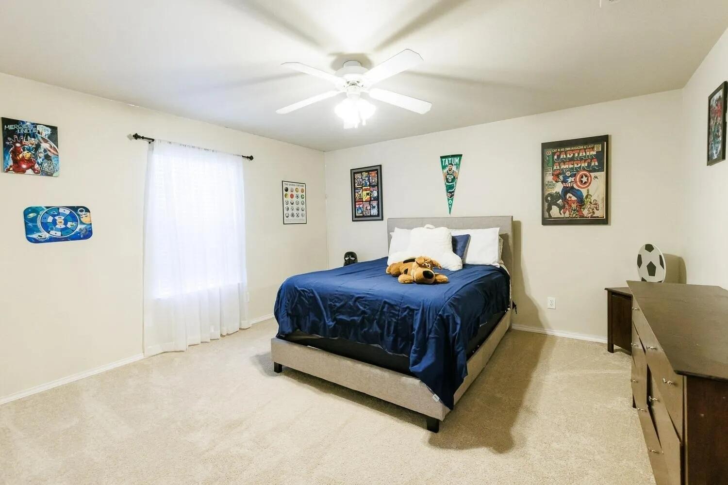 10602 Clinton Avenue Lubbock, TX 79424 - Photo 29 of 36 a bed sitting in a spacious bedroom next to a window