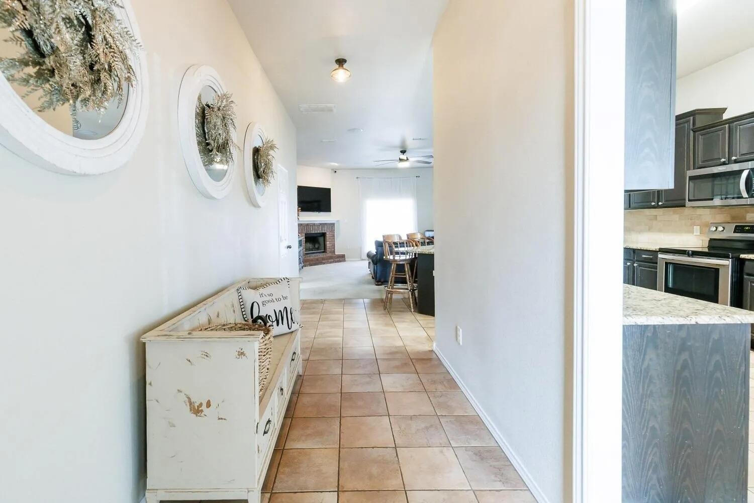 10602 Clinton Avenue Lubbock, TX 79424 - Photo 4 of 36 a hallway with dining table and chairs