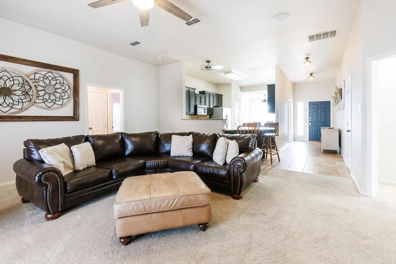 10602 Clinton Avenue Lubbock, TX 79424 - Photo 8 of 36 a view of a living room kitchen and a chandelier