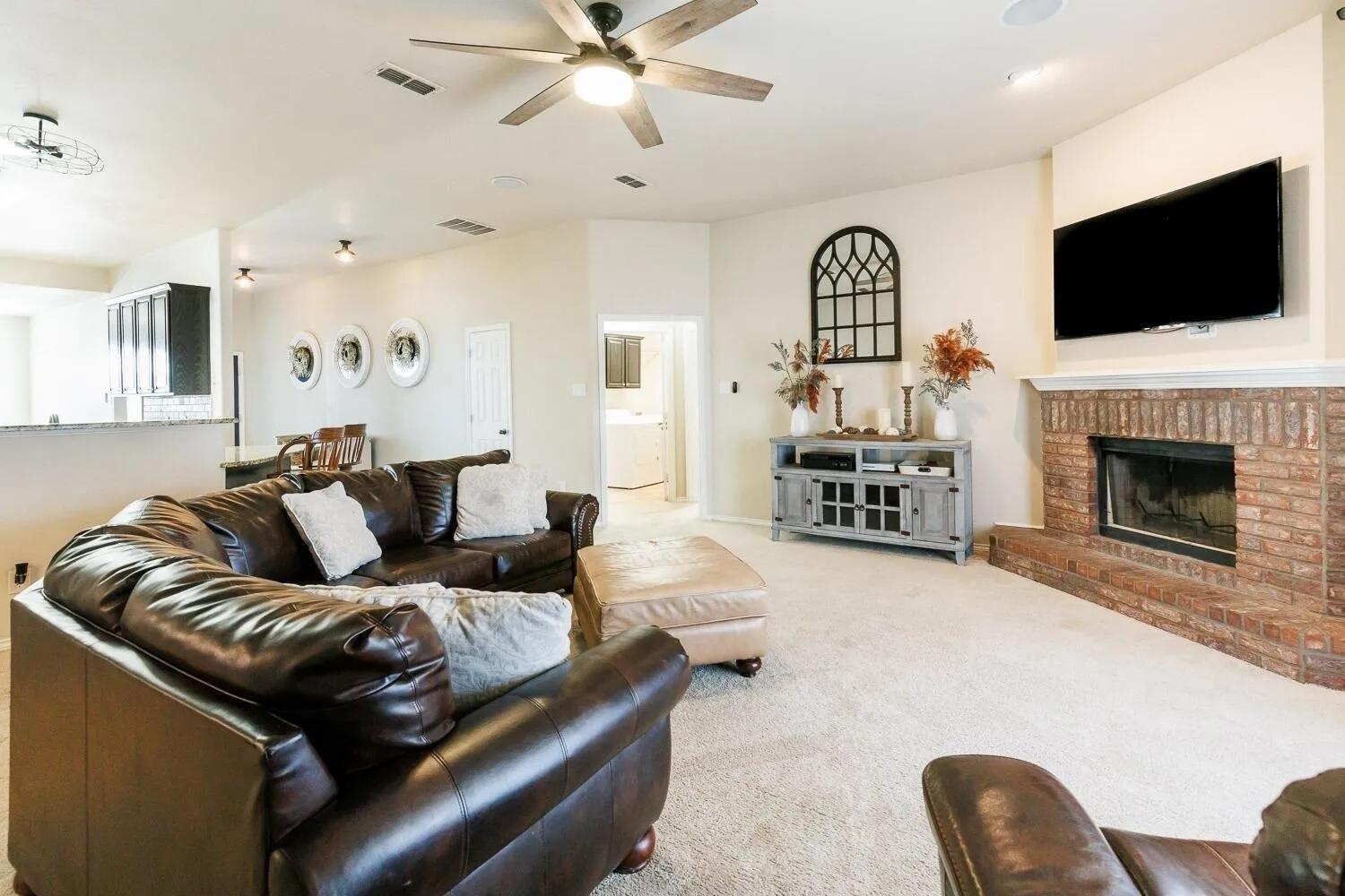 10602 Clinton Avenue Lubbock, TX 79424 - Photo 9 of 36 a living room with furniture fireplace and flat screen tv