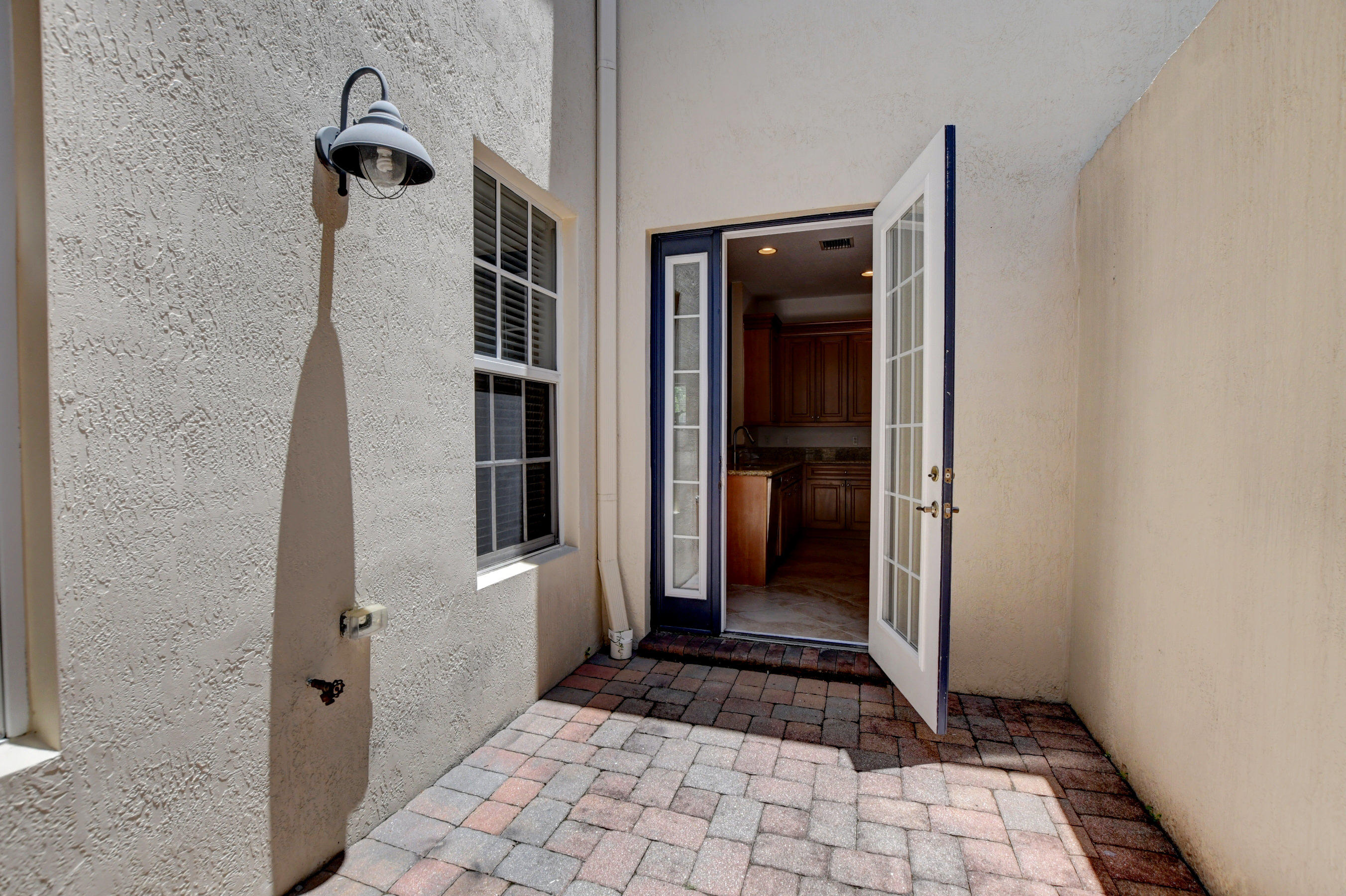 8308 Northwest 8th Way Boca Raton, FL 33487 - Photo 18 of 52 Outside patio leads to garage