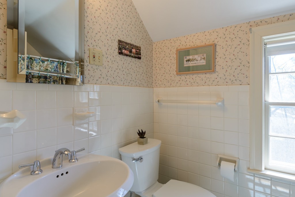 42 Earle Road Wellesley, MA 02481 - Photo 11 of 18 a bathroom with a sink mirror and toilet