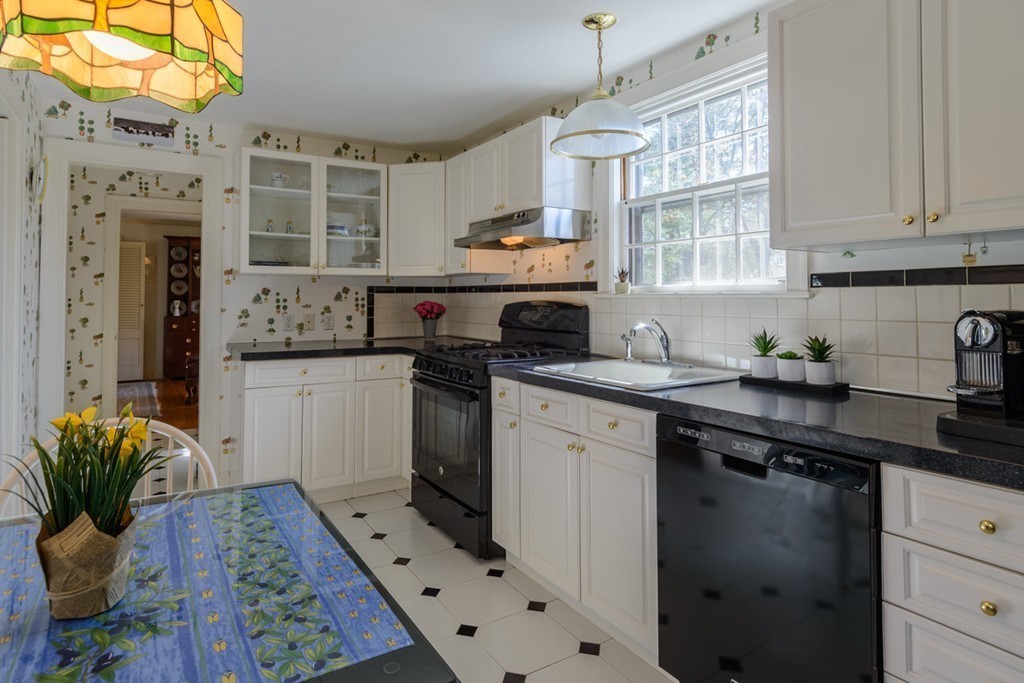 42 Earle Road Wellesley, MA 02481 - Photo 4 of 18 a kitchen with stainless steel appliances granite countertop a sink stove and cabinets