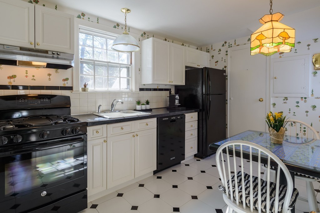 42 Earle Road Wellesley, MA 02481 - Photo 5 of 18 a kitchen with stainless steel appliances a stove a refrigerator and a sink