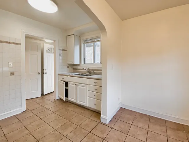 a kitchen with a sink a stove and cabinets