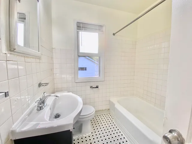 a view of a hallway with wooden floor and stairs