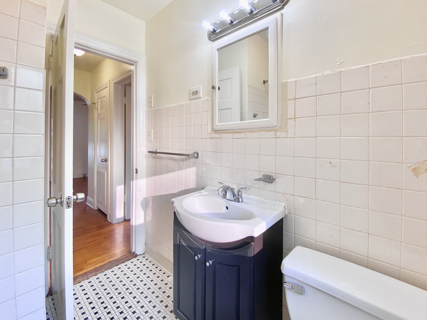 18034 Ridgewood Avenue Lansing, IL 60438 - Photo 22 of 35 a bathroom with a sink a toilet and shower