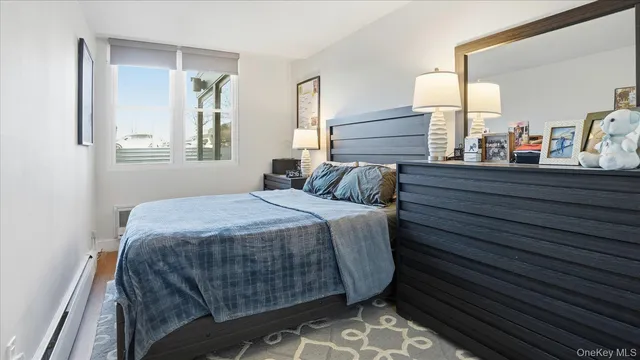 a bedroom with a bed and two windows