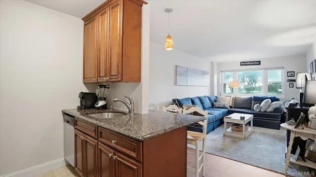 a view of a kitchen with granite countertop a sink and a stove