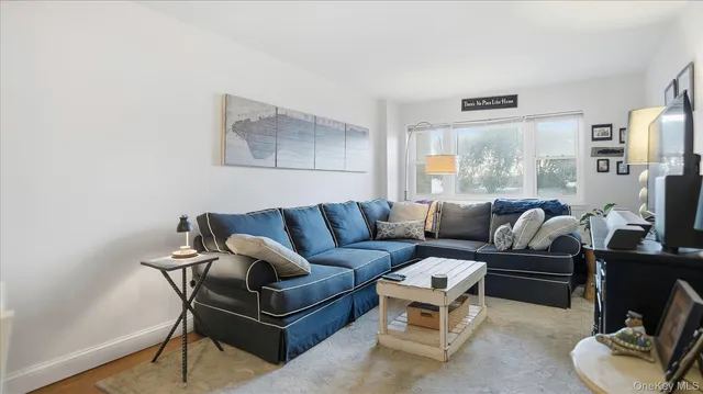 a living room with furniture a large window and a flat screen tv