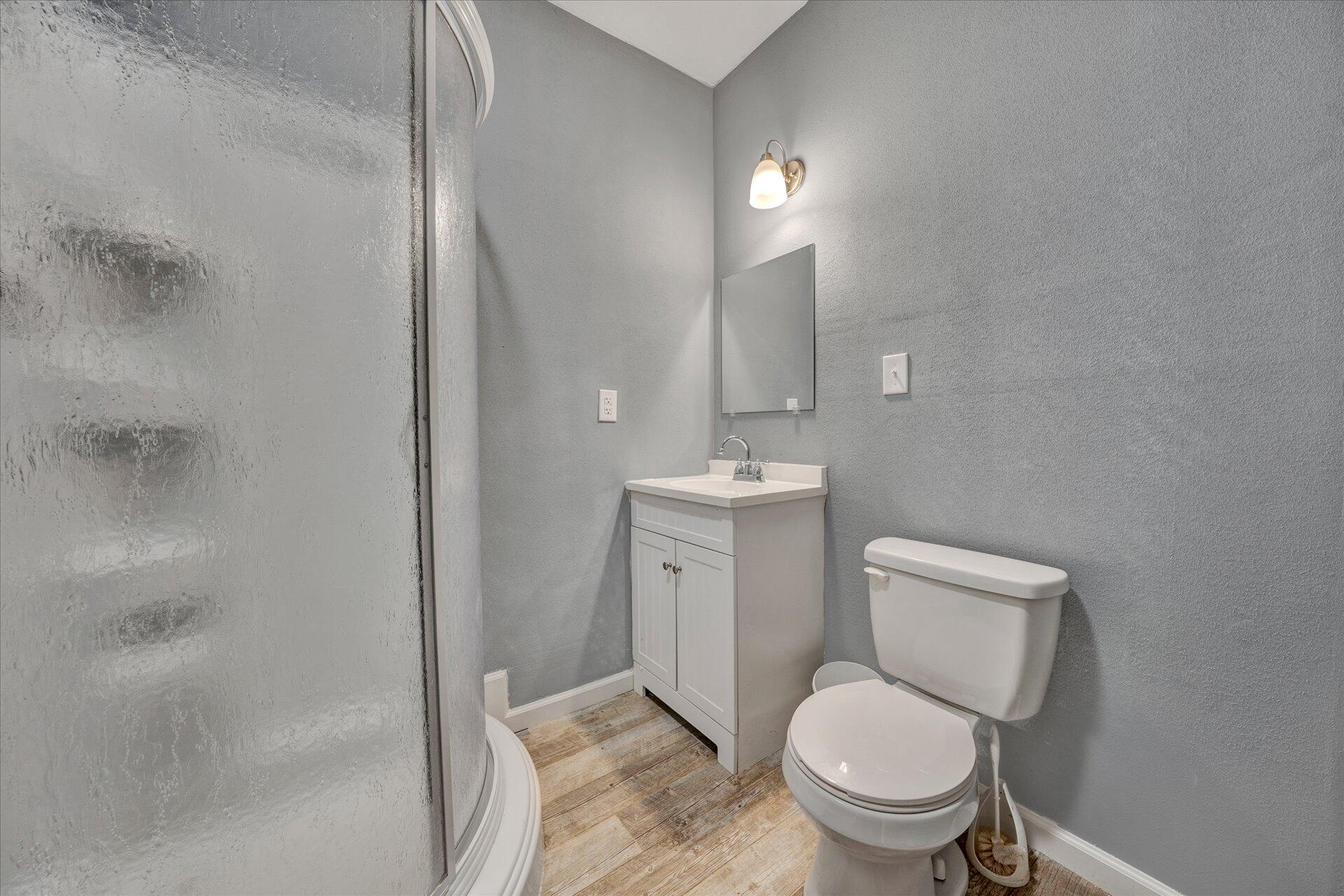 1081 Wooldridge Road Blue Ridge, VA 24064 - Photo 22 of 38 a bathroom with a toilet a sink and mirror
