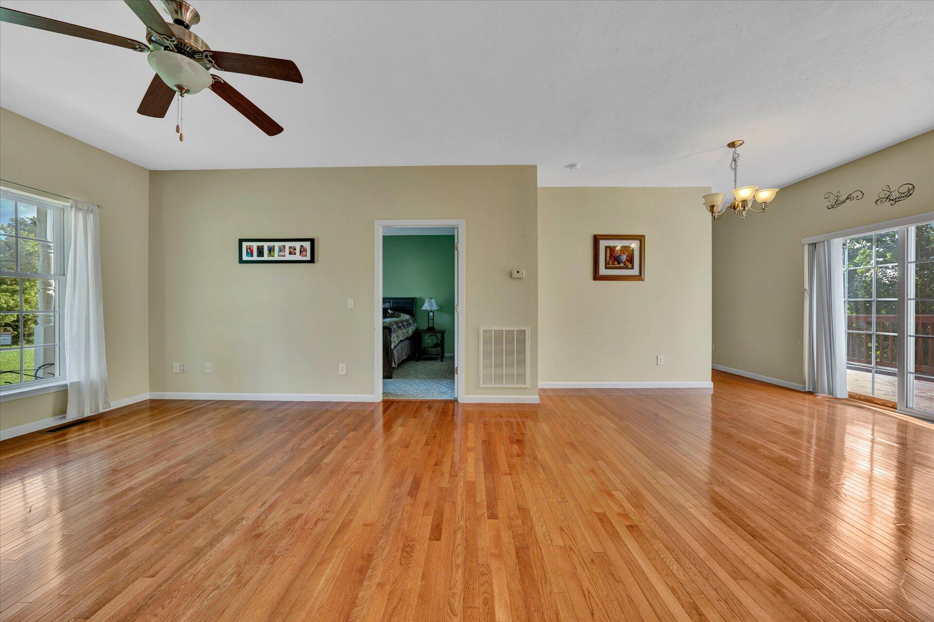 1081 Wooldridge Road Blue Ridge, VA 24064 - Photo 8 of 38 a view of empty room with wooden floor and fan