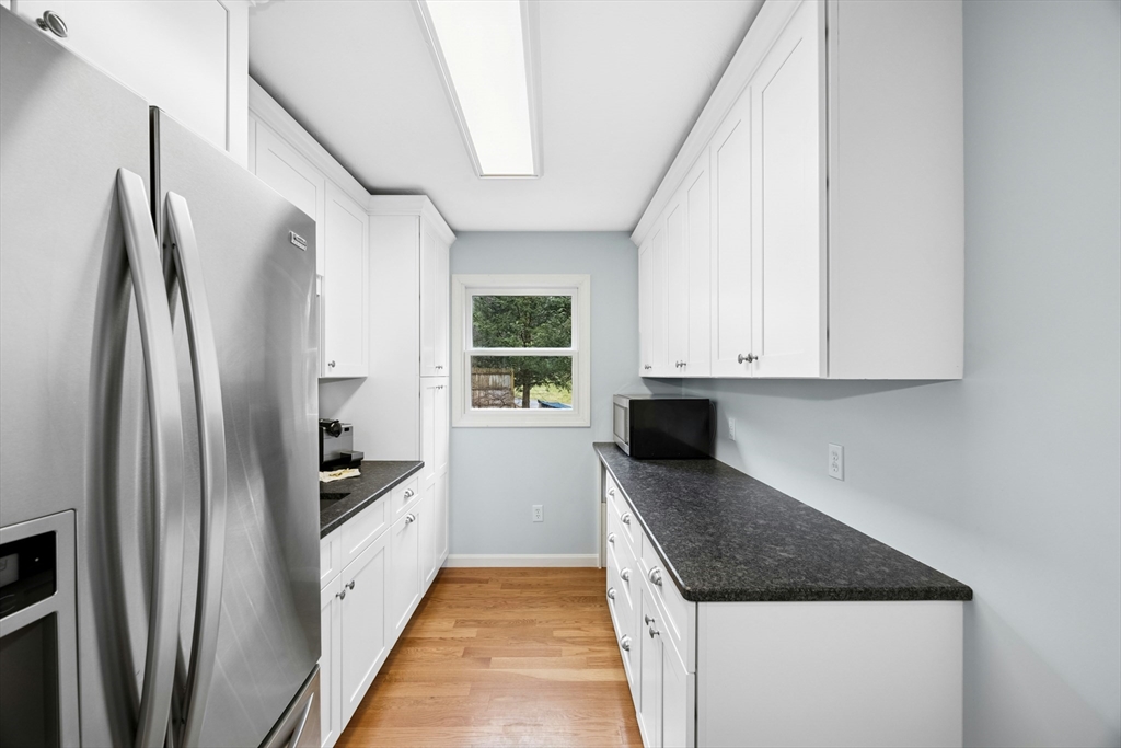 97 Willow Brook Road Holden, MA 01520 - Photo 14 of 42 a kitchen with stainless steel appliances granite countertop a refrigerator a stove and a sink with large window