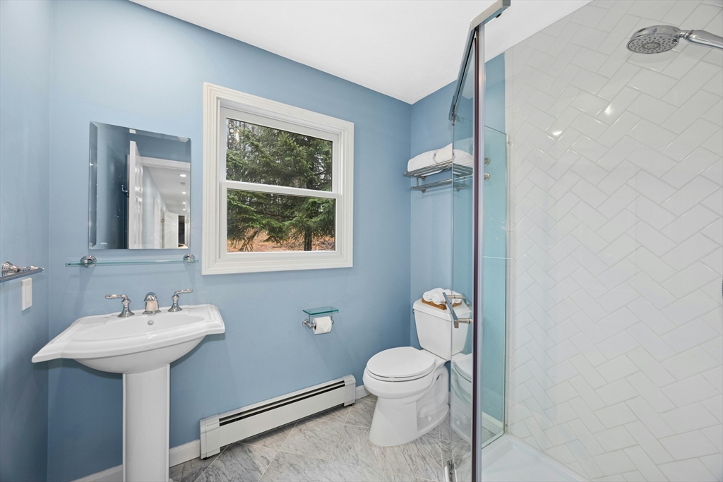 97 Willow Brook Road Holden, MA 01520 - Photo 17 of 42 a bathroom with a toilet sink and mirror