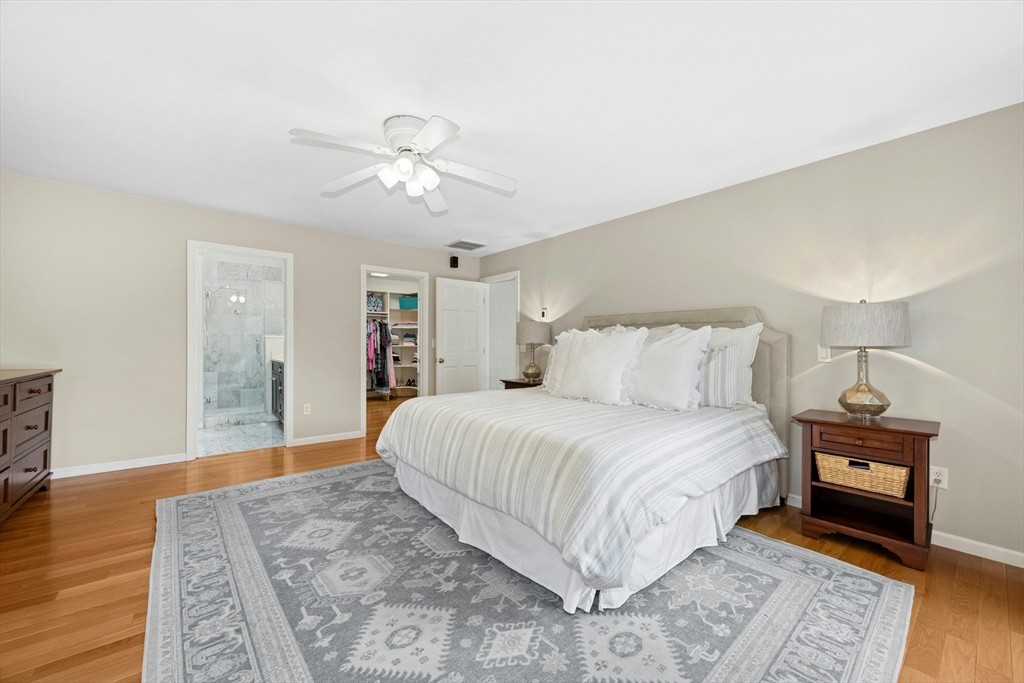 97 Willow Brook Road Holden, MA 01520 - Photo 23 of 42 a bedroom with a large bed and a chandelier