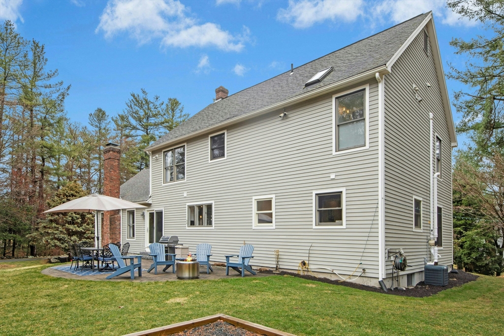 97 Willow Brook Road Holden, MA 01520 - Photo 36 of 42 a backyard of a house with yard table and chairs
