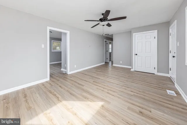 a view of an empty room and wooden floor