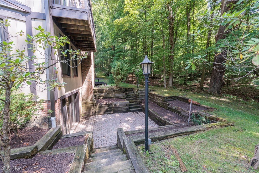 13655 Sperry Road Novelty, OH 44072 - Photo 23 of 32 View of yard featuring a vegetable garden and a balcony
