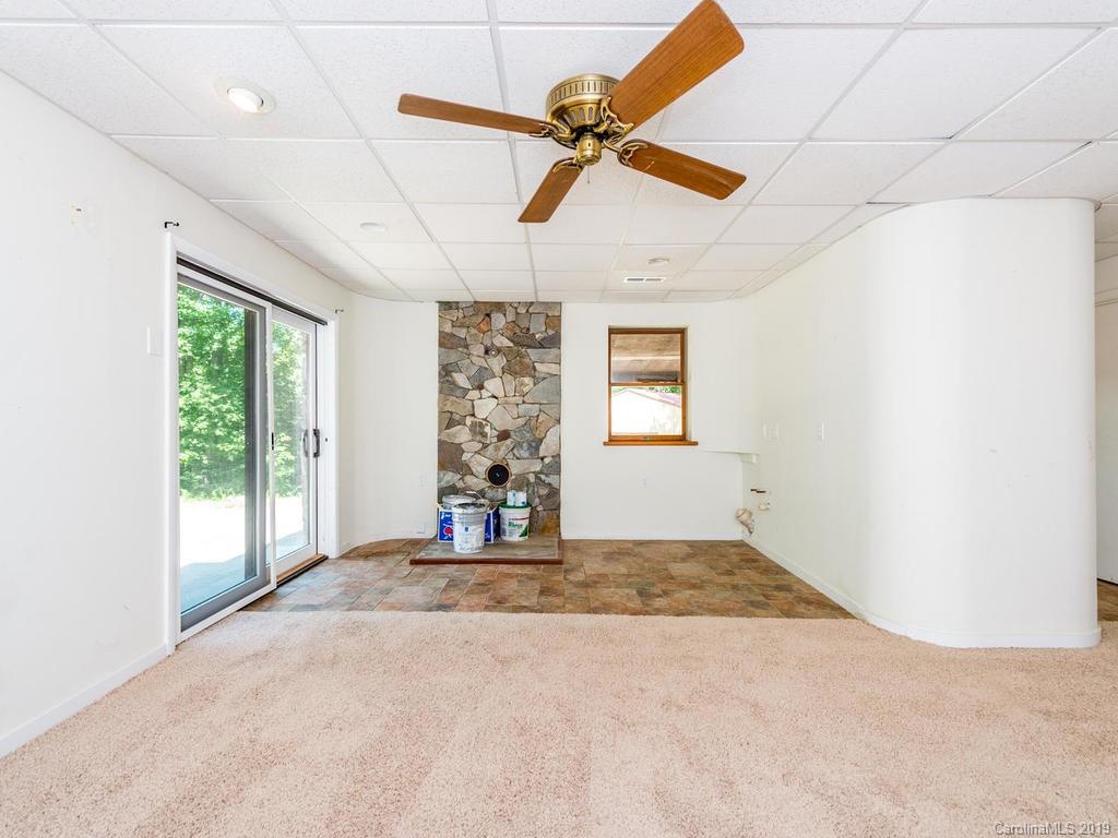 795 Springbrook Farm Road Waynesville, NC 28786 - Photo 14 of 45 a view of a livingroom with a ceiling fan and window