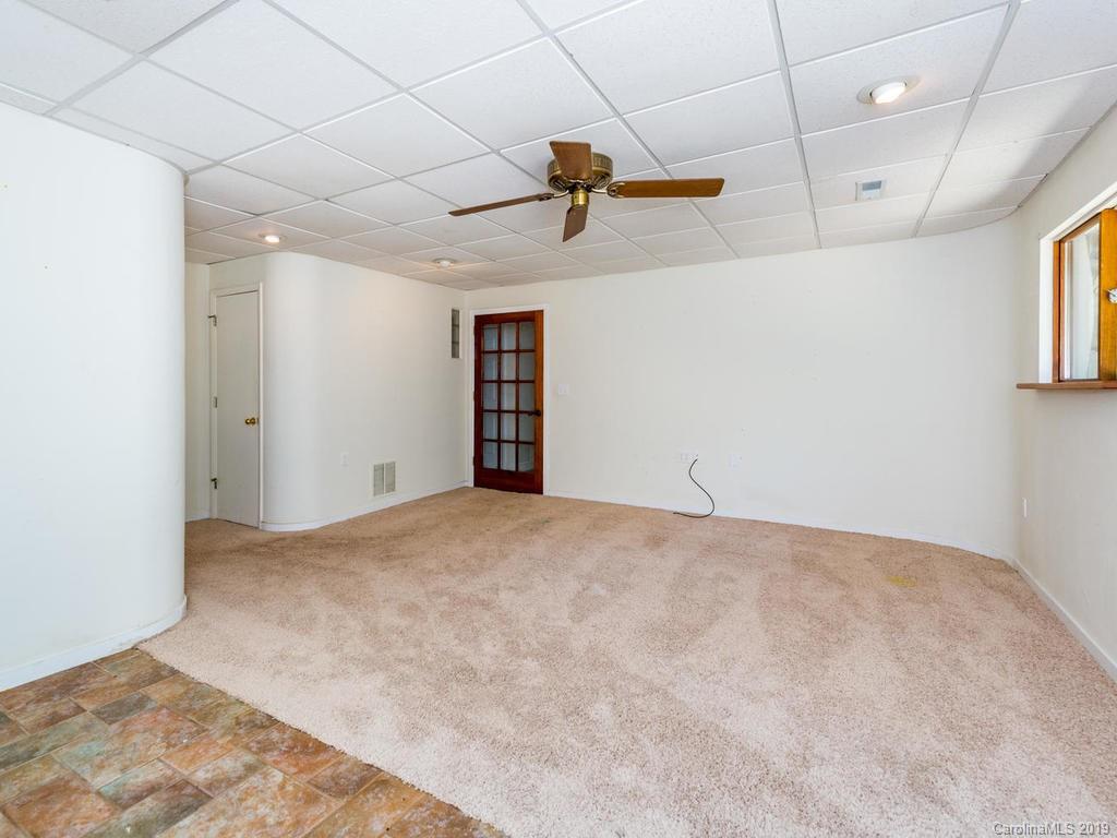795 Springbrook Farm Road Waynesville, NC 28786 - Photo 15 of 45 a view of a room with a ceiling fan and window