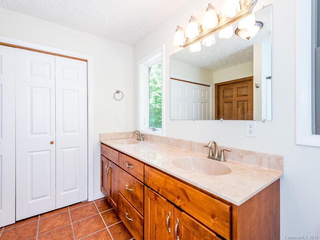 795 Springbrook Farm Road Waynesville, NC 28786 - Photo 20 of 45 a bathroom with a sink and a mirror