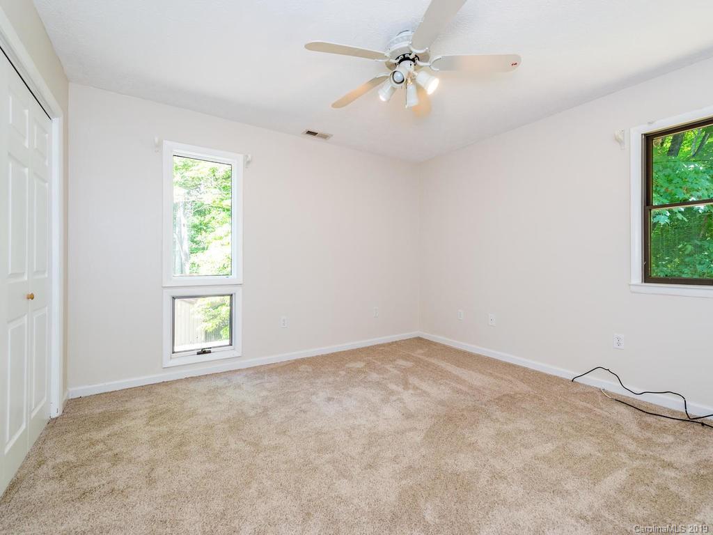 795 Springbrook Farm Road Waynesville, NC 28786 - Photo 23 of 45 wooden floor in an empty room with a window
