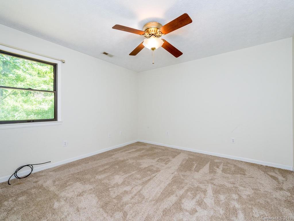 795 Springbrook Farm Road Waynesville, NC 28786 - Photo 24 of 45 a view of an empty room with a window