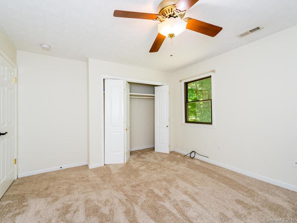 795 Springbrook Farm Road Waynesville, NC 28786 - Photo 25 of 45 a view of a big room with a ceiling fan and a window