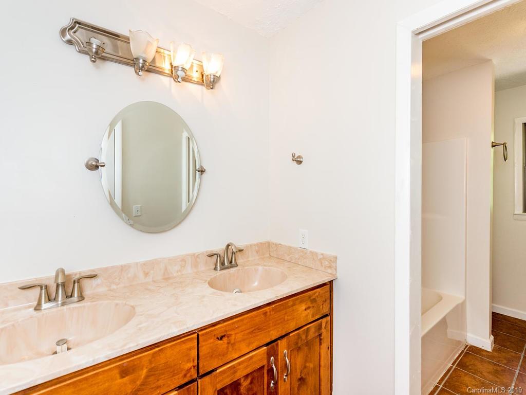 795 Springbrook Farm Road Waynesville, NC 28786 - Photo 26 of 45 a bathroom with a sink and a mirror