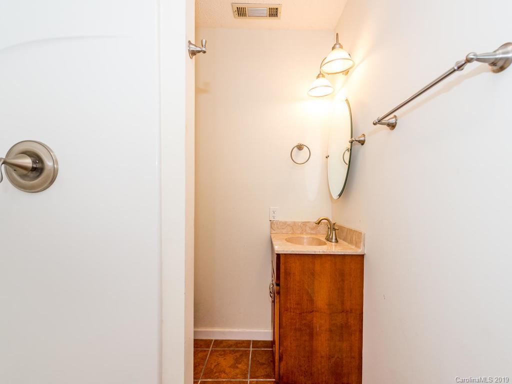 795 Springbrook Farm Road Waynesville, NC 28786 - Photo 29 of 45 a bathroom with a sink and mirror