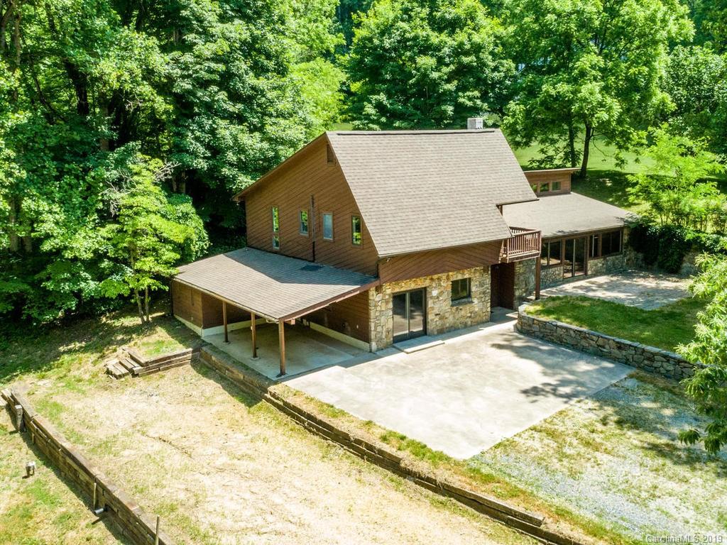 795 Springbrook Farm Road Waynesville, NC 28786 - Photo 43 of 45 a view of a backyard with furniture and a garden