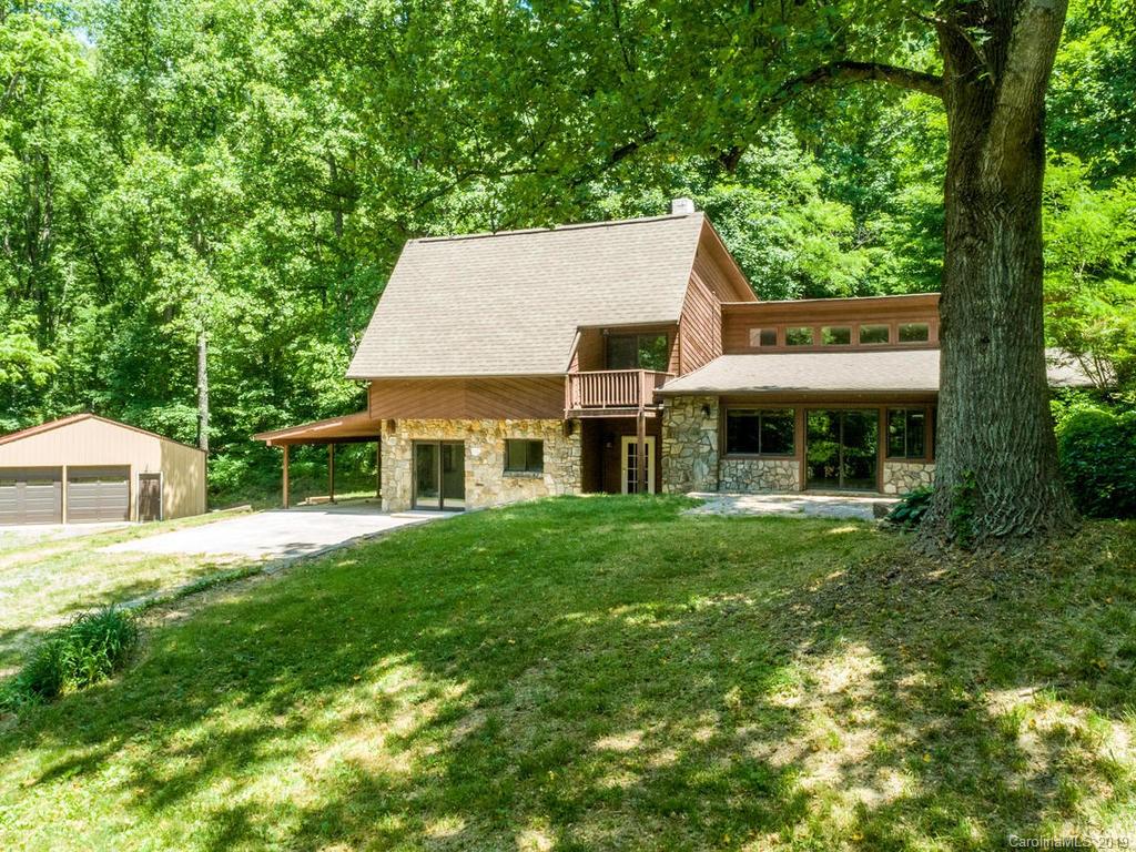 795 Springbrook Farm Road Waynesville, NC 28786 - Photo 45 of 45 a front view of a house with a garden and trees