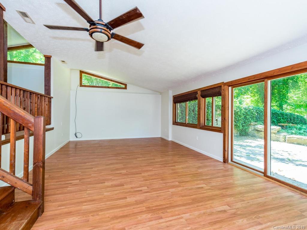 795 Springbrook Farm Road Waynesville, NC 28786 - Photo 6 of 45 a view of an empty room with a window