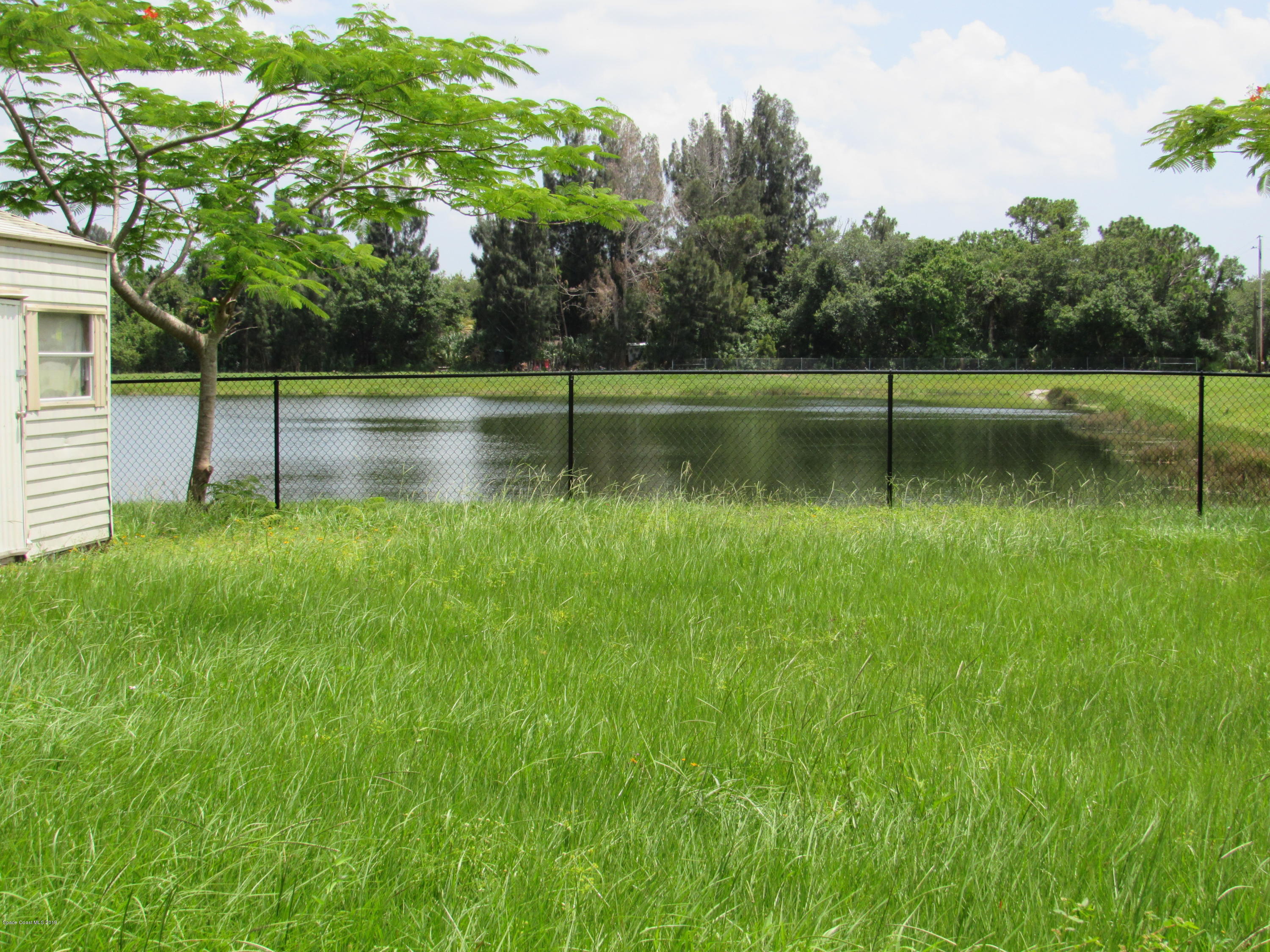 1399 Knecht Road Northeast Palm Bay, FL 32905 - Photo 34 of 35 Rear Yard View of Pond