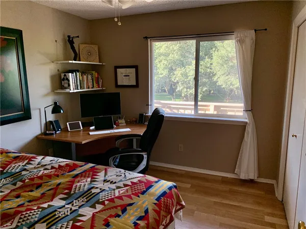 a bedroom with a bed and dresser