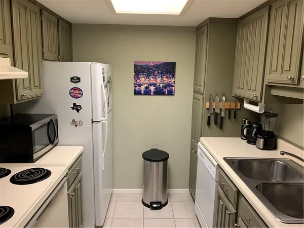 a kitchen that has a sink and a stove in it